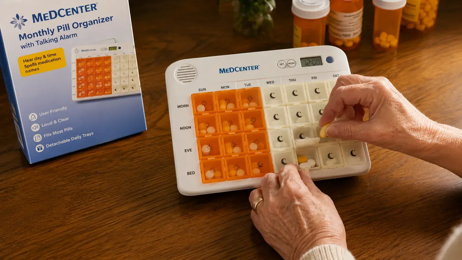 Close-up of hands filling the Medcenter pill organizer trays, with prescription bottles arranged in a row nearby